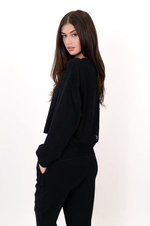 Model wearing The Solace Crew Neck in Onyx by ON/OFF Essentials, made from 95% bamboo fleece.