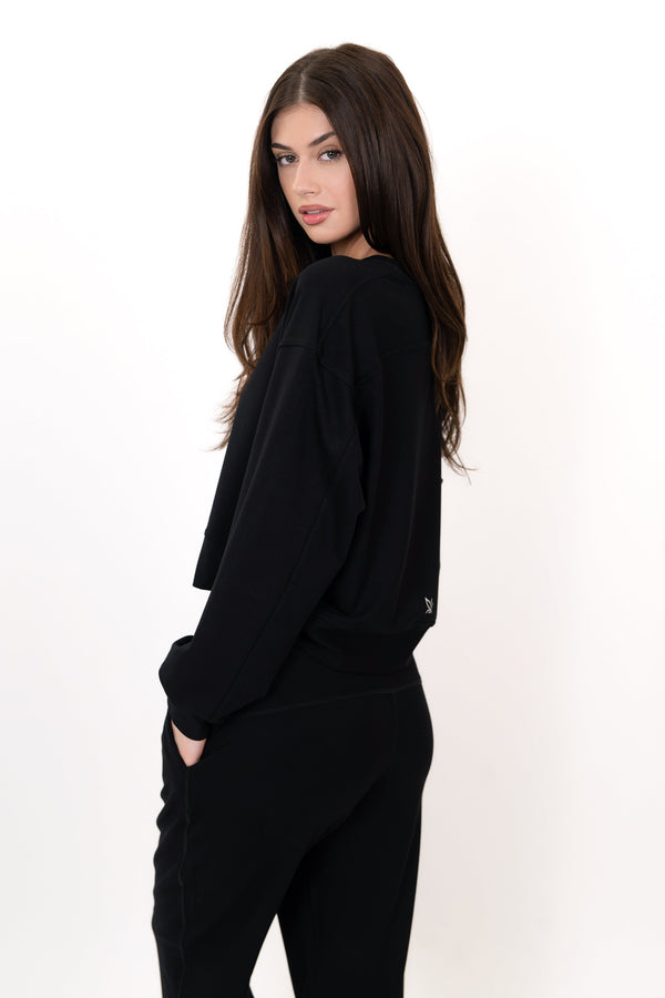 Model wearing The Solace Crew Neck in Onyx by ON/OFF Essentials, made from 95% bamboo fleece.