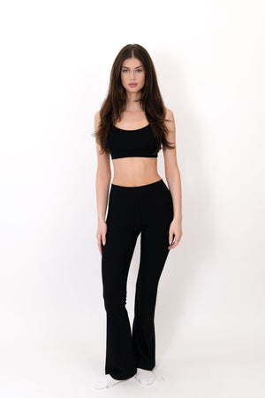 Model wearing The Core Flare Legging in Onyx by ON/OFF Essentials, made from 95% bamboo.