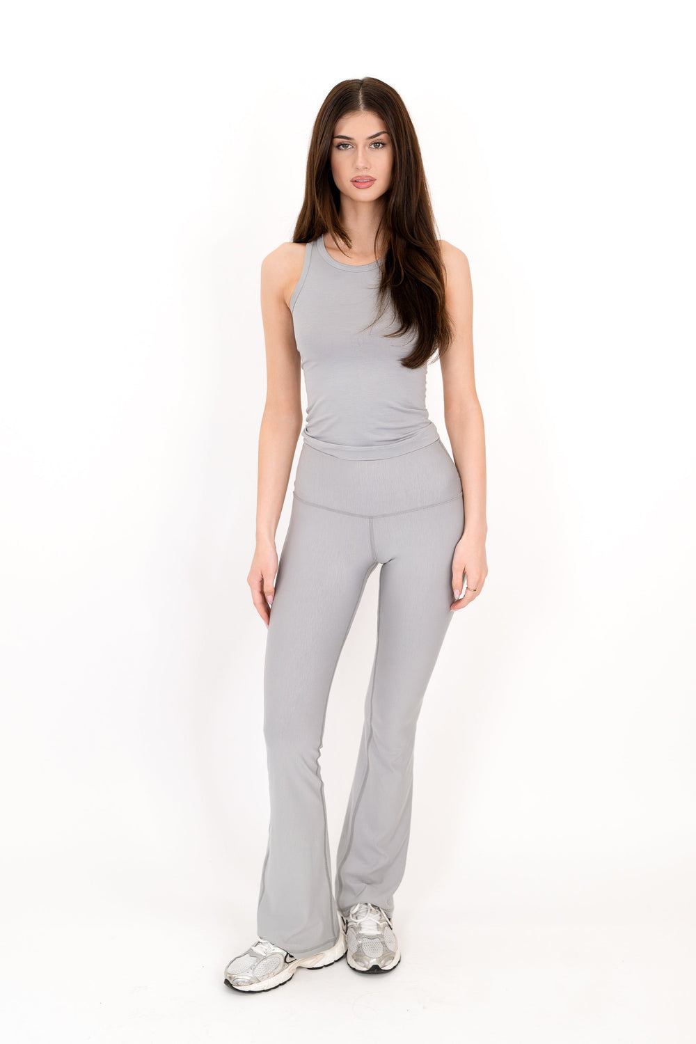 Gray flare legging with high-rise fit and smooth tapered bootcut legs.