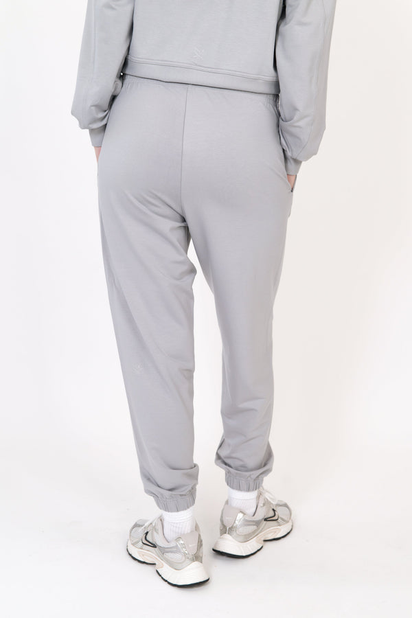 Model wearing The Solace Sweatpant in Fog by ON/OFF Essentials, made from 95% bamboo fleece.