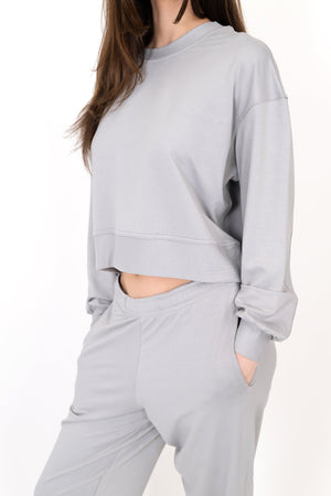 Model wearing The Solace Crew Neck in Fog by ON/OFF Essentials, made from 95% bamboo fleece.