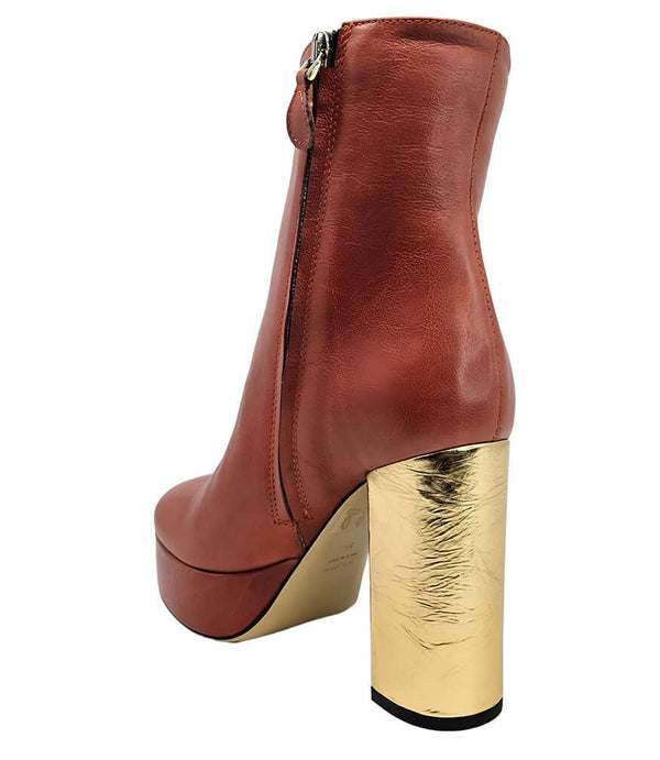 "High-heel ankle boot crafted from smooth premium leather with a sleek rounded toe, an inner side zipper for easy wear, a supportive leather-wrapped platform, and a sturdy metallic block heel. Designed with a soft leather lining and a durable leather sole