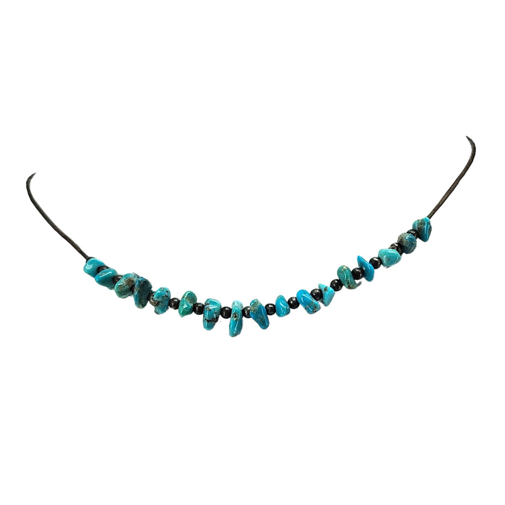 Turquoise howlite beaded necklace with metal clasp on long dark cord