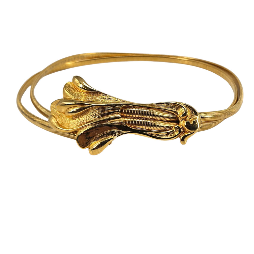 Gold stretch belt with snake-swirled metal buckle and ribbed flexible strap