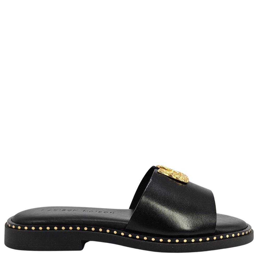 Black sandal with gold accents on a white background