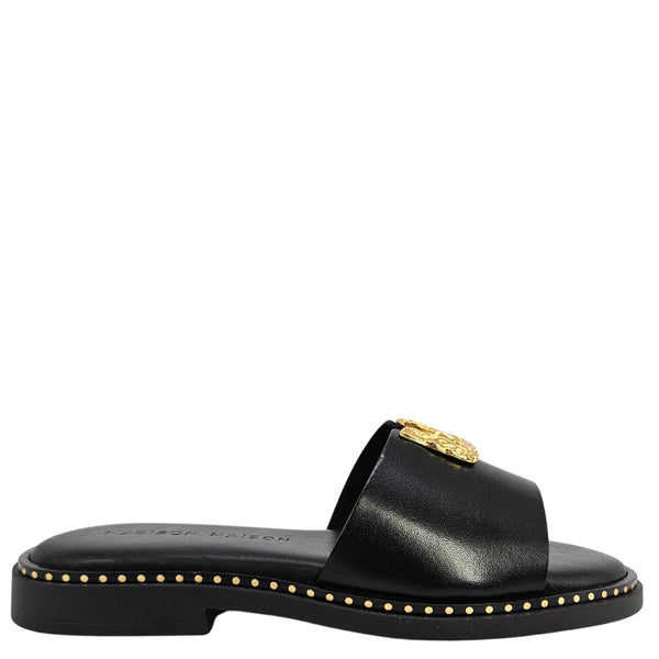 Black sandal with gold accents on a white background