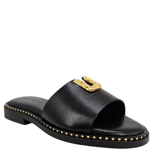 Black sandal with gold embellishments on a white background