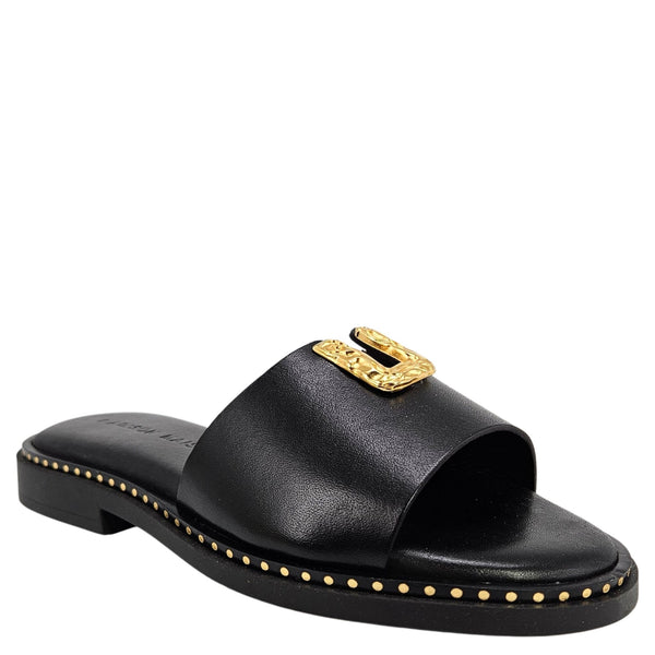 Black sandal with gold embellishments on a white background