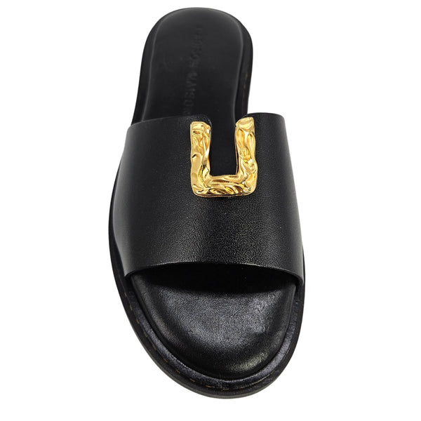 Black sandal with a gold buckle on a white background