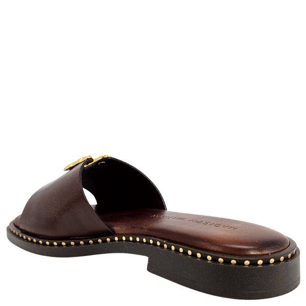 Brown sandal with gold accents on a white background