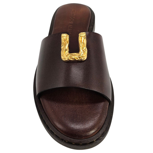 Brown sandal with a gold buckle on a white background