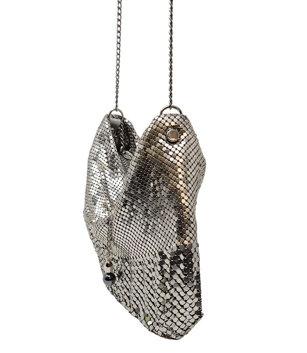 "Small chainmail mesh shoulder bag with a soft, slouchy silhouette, fine metal disc overlay, and a delicate chain strap. Features a gathered top opening with a decorative metal charm detail. Lightweight design ideal for evening or special occasions. Craft