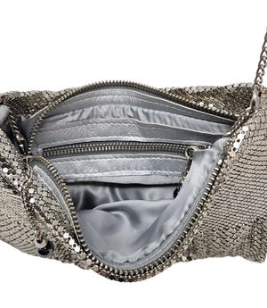 "Small chainmail mesh shoulder bag with a soft, slouchy silhouette, fine metal disc overlay, and a delicate chain strap. Features a gathered top opening with a decorative metal charm detail. Lightweight design ideal for evening or special occasions. Craft
