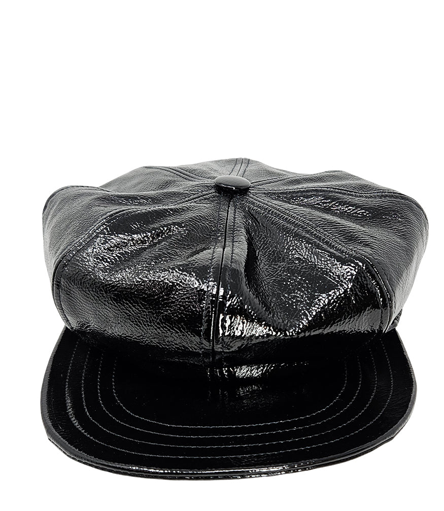 Structured newsboy cap crafted in textured material with panel stitching, a covered button top, and a short curved brim