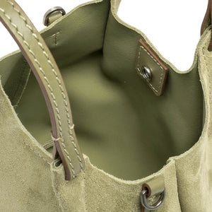 Close-up of a green leather handbag with stitching details