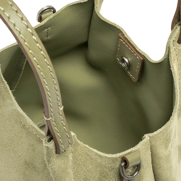 Close-up of a green leather handbag with stitching details