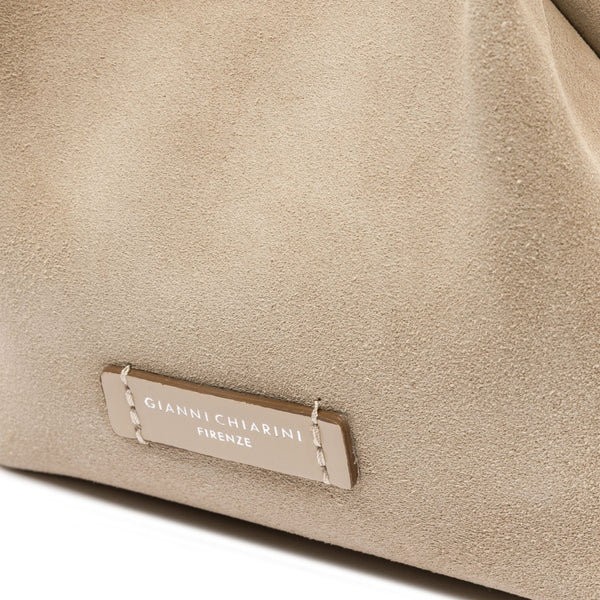 Close-up of a beige textured bag with a brand label on a white background