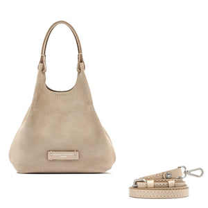 Close-up of a beige textured bag with a brand label on a white background
