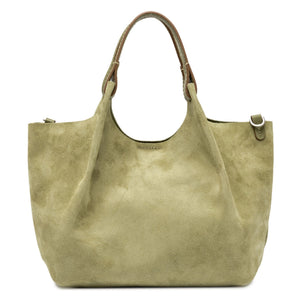 Green suede handbag with brown leather handle on a white background