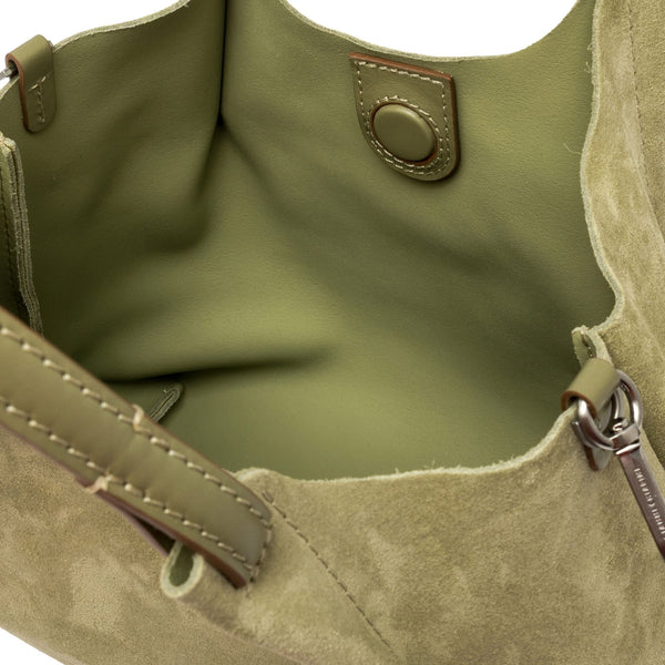 Close-up of a green handbag with visible stitching and a keychain.