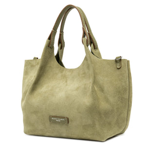 Green handbag with a visible brand label on a white background