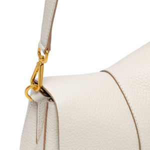 Close-up of a white handbag with a gold clasp on a white background