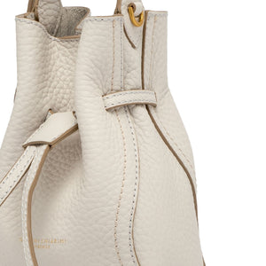 Close-up of a beige leather handbag with visible stitching on a white background