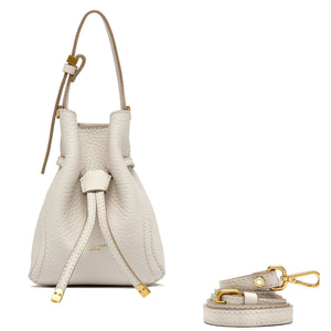 White leather handbag with matching strap and keychain on a white background