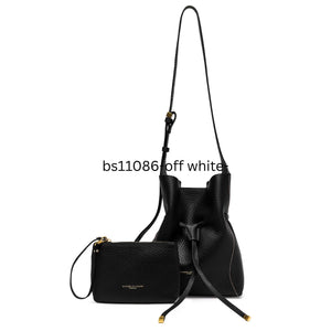 Black leather handbag with matching pouch on a white background