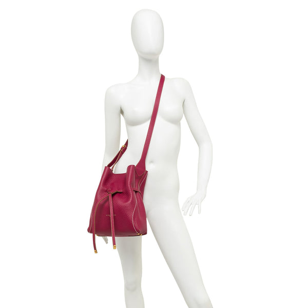 Mannequin wearing a red handbag on a white background