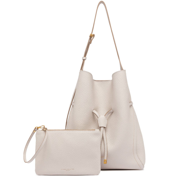 Set of two cream-colored handbags with matching pouch on a white background