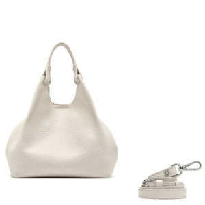 White textured handbag with matching keychain on a white background