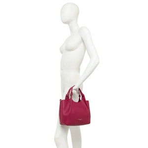 Mannequin holding a pink handbag on a white background