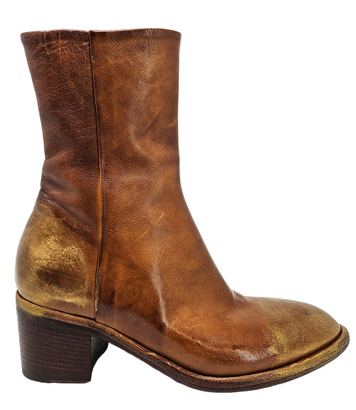 Mid-heel ankle boot crafted from premium leather with a softly rounded toe, artisanal distressed detailing at the toe and heel, and a stacked block heel. Features a full side zipper for easy entry, a leather-lined interior for comfort, and a durable leath