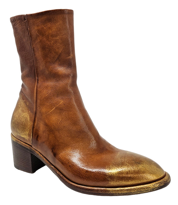 Mid-heel ankle boot crafted from premium leather with a softly rounded toe, artisanal distressed detailing at the toe and heel, and a stacked block heel. Features a full side zipper for easy entry, a leather-lined interior for comfort, and a durable leath