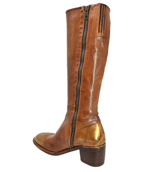Tall leather boot featuring a softly rounded toe, mid-height stacked block heel, full side zipper for easy on and off, and a decorative metal lock accent near the top shaft. Crafted from premium leather with artisanal distressed detailing at the toe and h