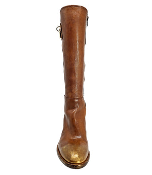 Tall leather boot featuring a softly rounded toe, mid-height stacked block heel, full side zipper for easy on and off, and a decorative metal lock accent near the top shaft. Crafted from premium leather with artisanal distressed detailing at the toe and h