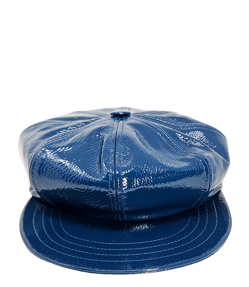 Structured newsboy cap crafted in textured material with panel stitching, a covered button top, and a short curved brim
