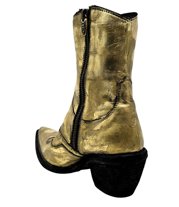 Mid-calf western-style boot featuring a distressed gold metallic finish, pointed toe, angled block heel, and contrast stitching. Designed with decorative panel overlays and a side zipper closure - back side view