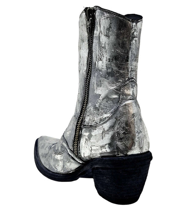 Mid-calf western-style boot featuring a distressed silver metallic finish, pointed toe, angled block heel, and contrast stitching. Designed with decorative panel overlays and a side zipper closure - back view