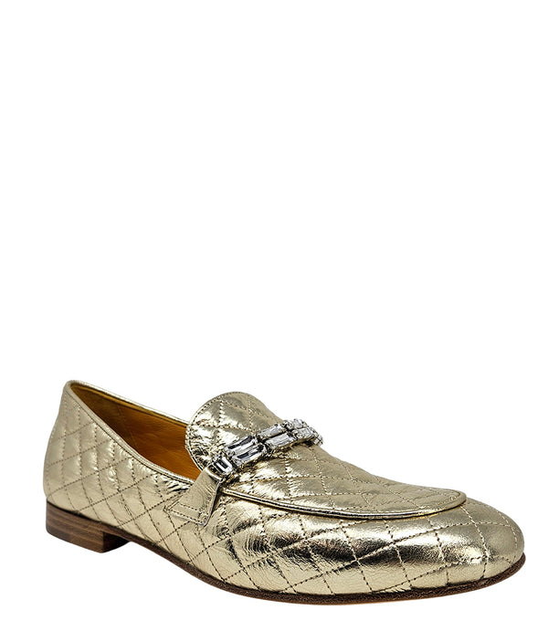 A quilted leather flat loafer with a low stacked heel and rounded toe, featuring a decorative strap adorned with rectangular gemstone-style embellishments. Designed by Madison in Beverly Hills and handcrafted in Italy.