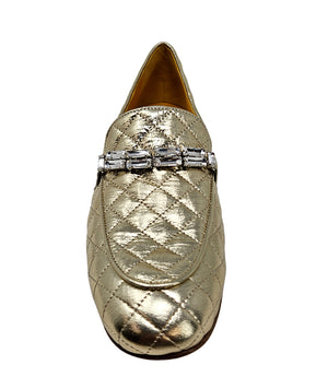 A quilted leather flat loafer with a low stacked heel and rounded toe, featuring a decorative strap adorned with rectangular gemstone-style embellishments. Designed by Madison in Beverly Hills and handcrafted in Italy.