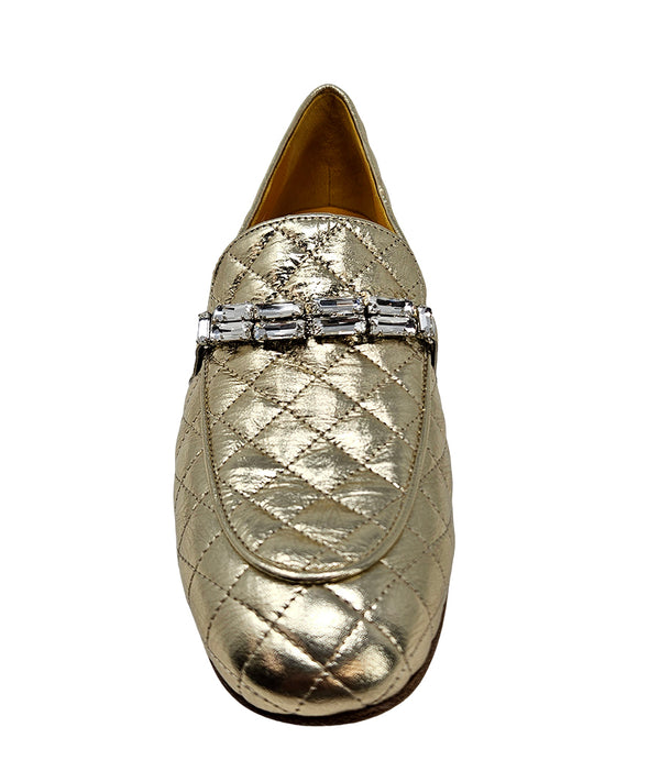 A quilted leather flat loafer with a low stacked heel and rounded toe, featuring a decorative strap adorned with rectangular gemstone-style embellishments. Designed by Madison in Beverly Hills and handcrafted in Italy.