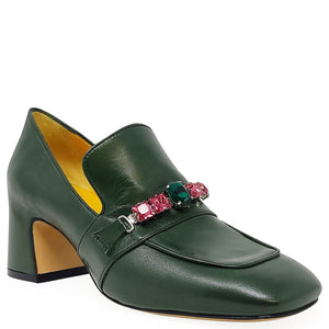Green loafer shoe with gemstone embellishments on a white background