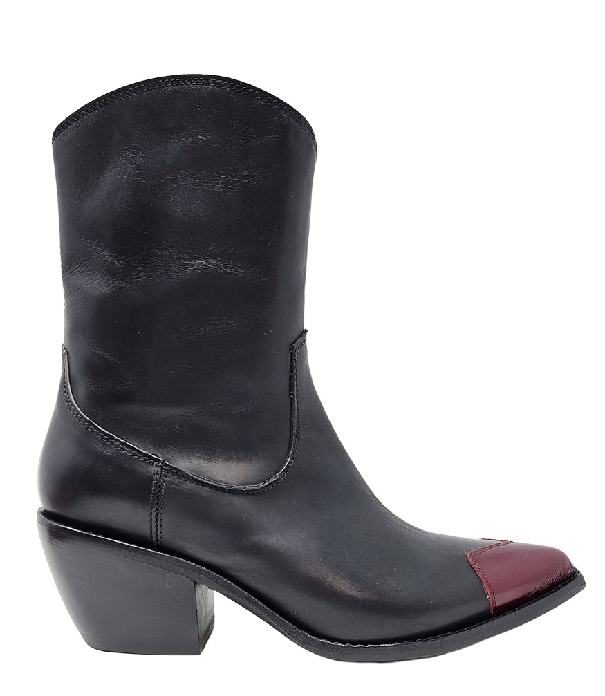 Mid-calf leather boot with block heel, side zipper, and contrasting heart-shaped toe cap. Features a structured silhouette with a pointed toe and minimal seam lines.