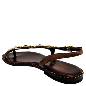 Brown sandal with gold accents on a white background