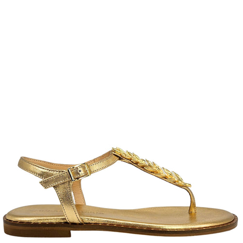 Gold sandal with decorative strap on a white background