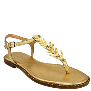 Gold sandal with decorative leaf design on a white background