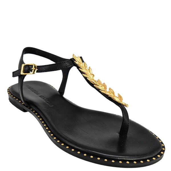 Black sandal with gold accents on a white background